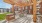 Outdoor pergola with seating and grills on a patio