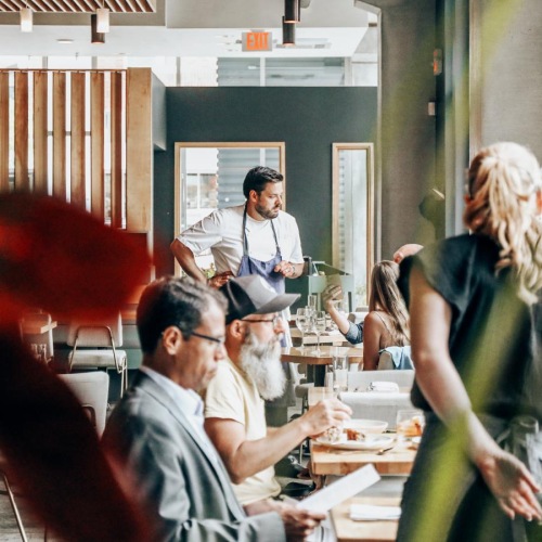 Bustling community with plenty of dining choices people and waiters in neighborhood restaurant