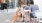 dog sits next to a couple at an outdoor table