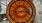 Warmly lit circular ceiling design with wood paneling