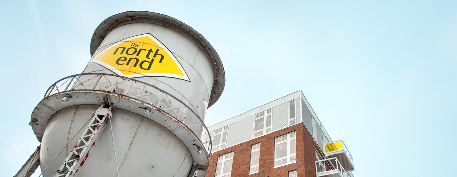 water tower with The North End logo next to apartments